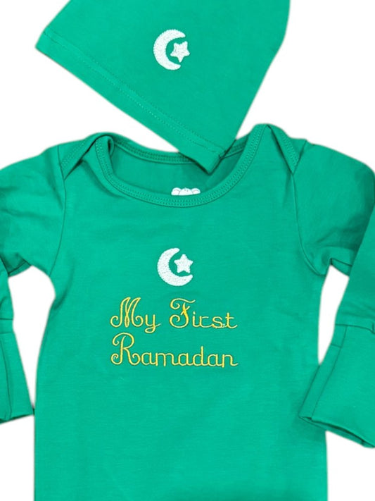 Green baby onesie with 'My First Ramadan' text and matching hat on a white background