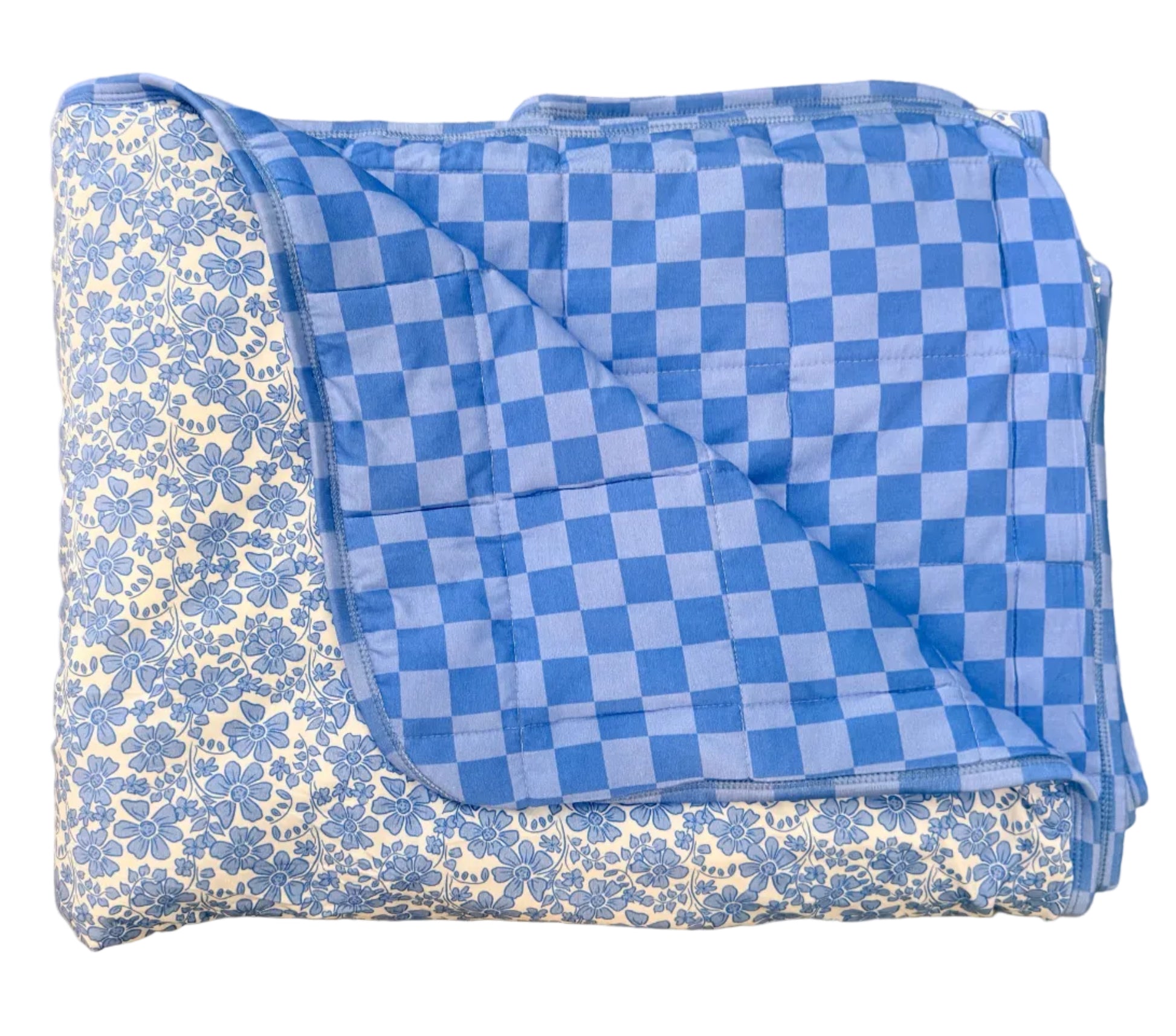 Folded blue and white checkered blanket on a beige floor.