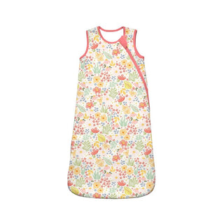 Floral patterned baby sleeping bag with pink trim on a white background