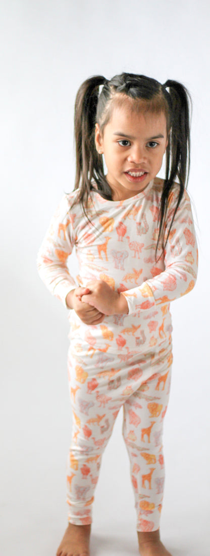 Child wearing a patterned onesie on a white background