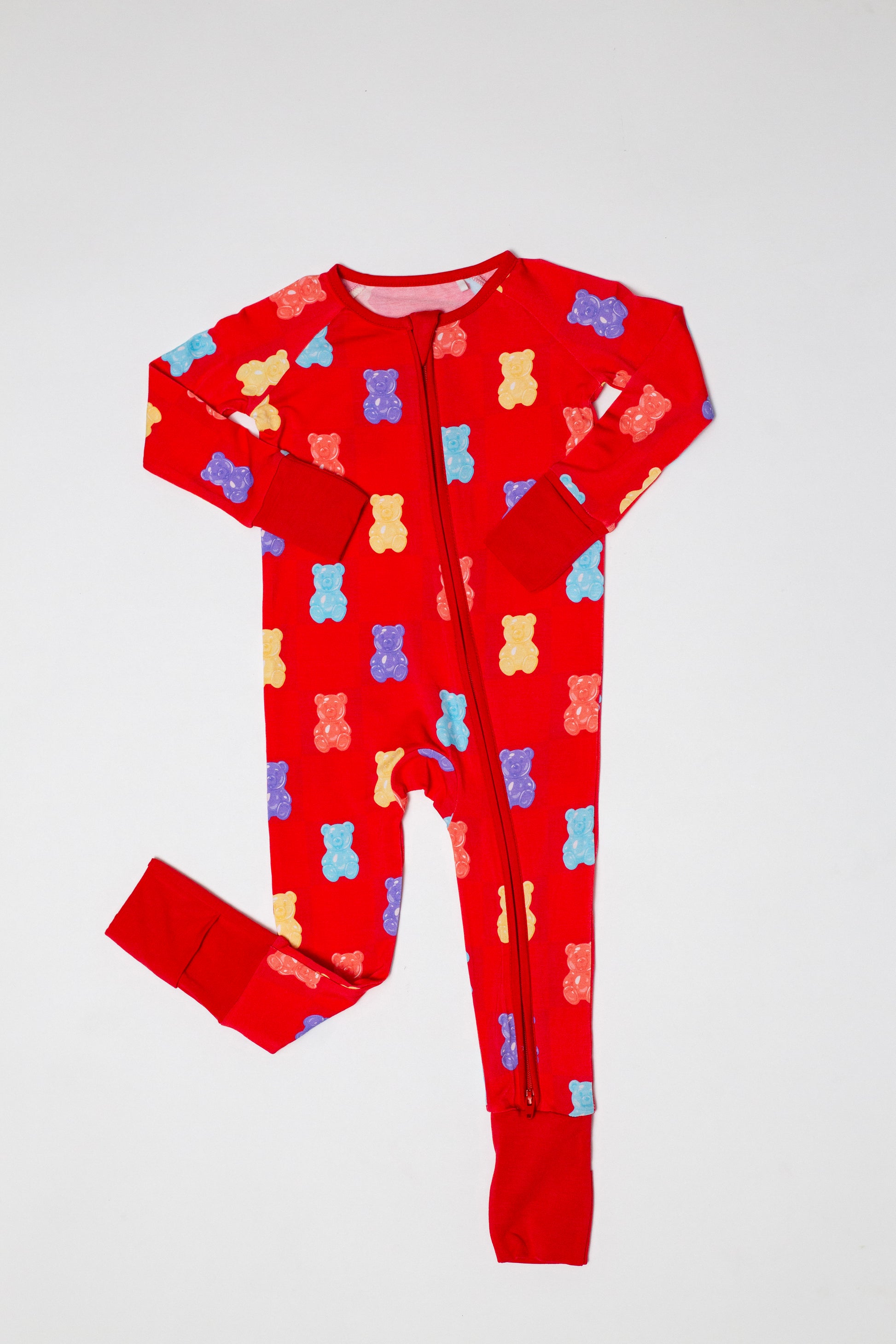 Red onesie with colorful bear pattern on a white background