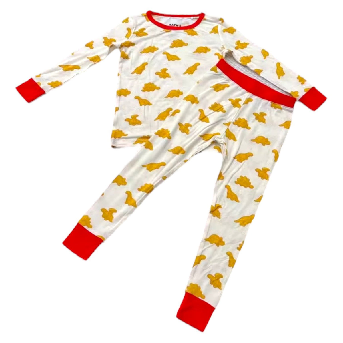 Children's pajama set with yellow animal pattern and red cuffs on a white background