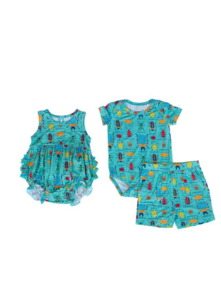 Children's outfit set with romper, shirt, and shorts on a light blue background