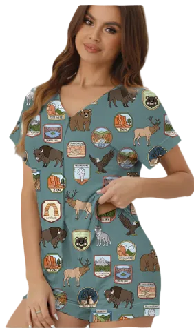 Woman wearing a teal dress with nature-themed graphics on a white background